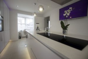 white quartz kitchen island showing black hob