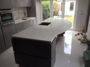 kitchen island with breakfast bar and white quartz