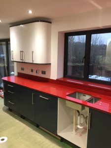 red starlight rosso stella urban quartz with grey glossy kitchen