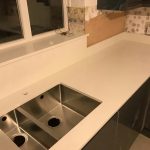 bianco nevoso quartz worktops with dark grey gloss kitchen