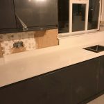 bianco nevoso quartz worktops with dark grey gloss kitchen