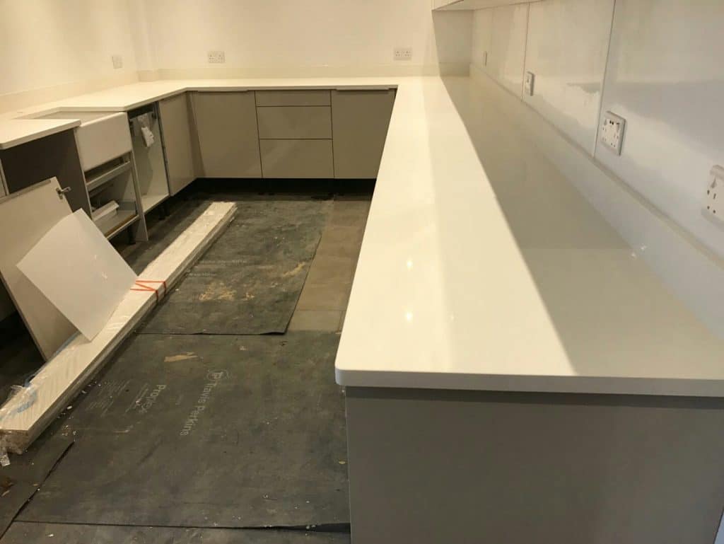 bianco nevoso white quartz installed in grey gloss kitchen dane end ware