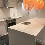 bianco nevoso white quartz island in white kitchen