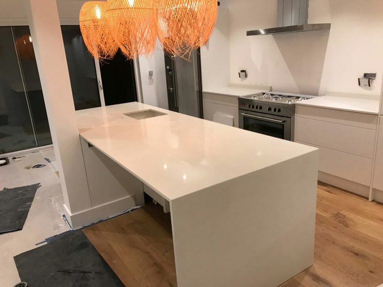 bianco nevoso white quartz island in white kitchen