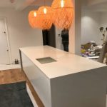 bianco nevoso white quartz island in white kitchen