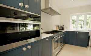 bianco puro pure white quartz worktops in blue traditional kitchen