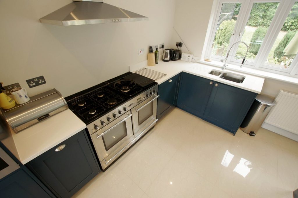 bianco puro pure white quartz worktops in blue traditional kitchen