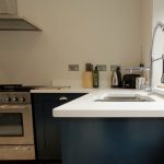 bianco puro pure white quartz worktops in blue traditional kitchen