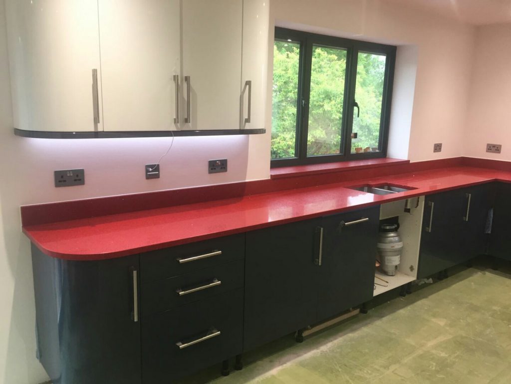 rosso stella red starlight quartz worktops in grey kitchen