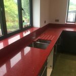 rosso stella red starlight quartz worktops in grey kitchen
