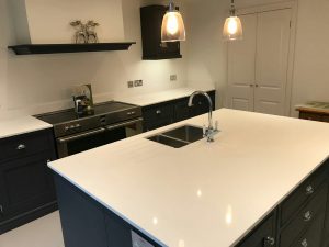 bianco puro white quartz worktops in traditional blue kitchen