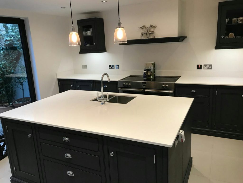 bianco puro white quartz worktops in traditional blue kitchen