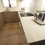 bianco puro pure white quartz worktops in taupe high gloss kitchen