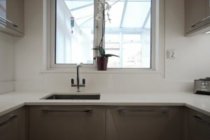 bianco puro pure white quartz worktops in taupe high gloss kitchen