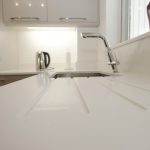 bianco puro pure white quartz worktops in taupe high gloss kitchen