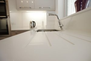 bianco puro pure white quartz worktops in taupe high gloss kitchen