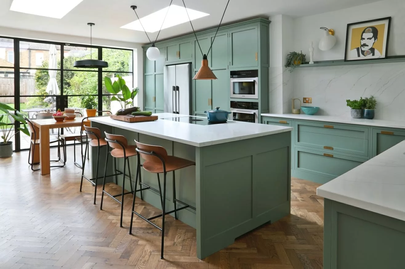 Rock & Co kitchen installation with pale quartz island and green cabinetry